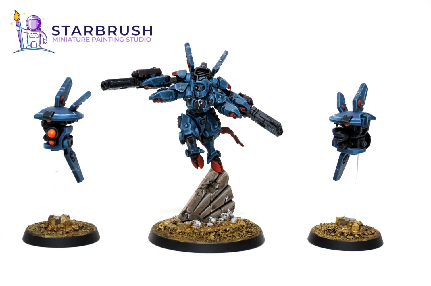 Commander Shadowsun XV22 battlesuit from Warhammer 40k painted in blue and orange to Level 2 leaping over stone rubble